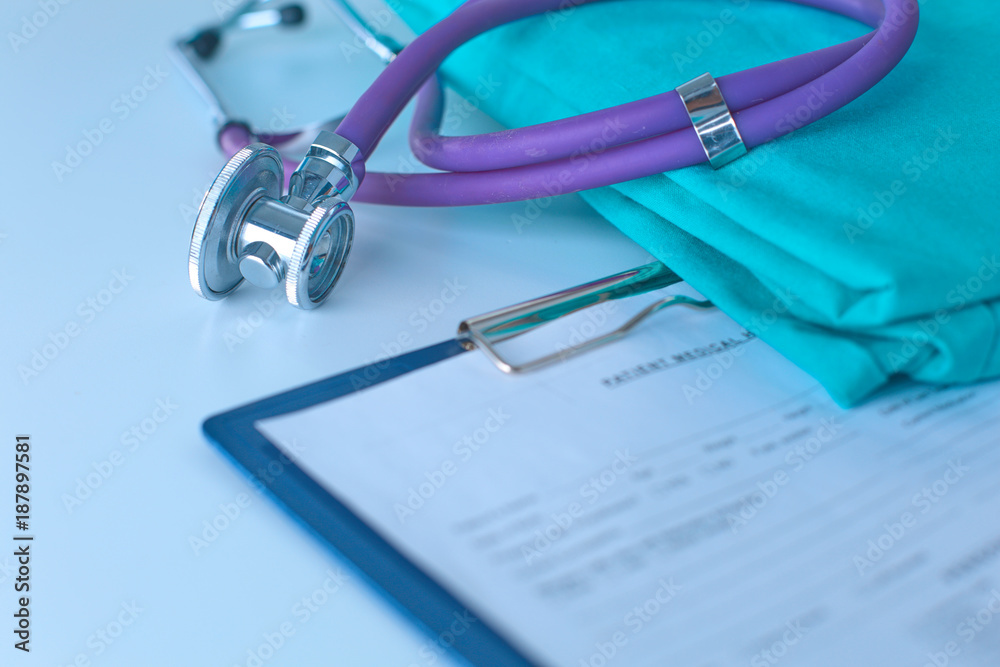 Stethoscope on a table with medical uniform Stethoscope on a table with medical uniform