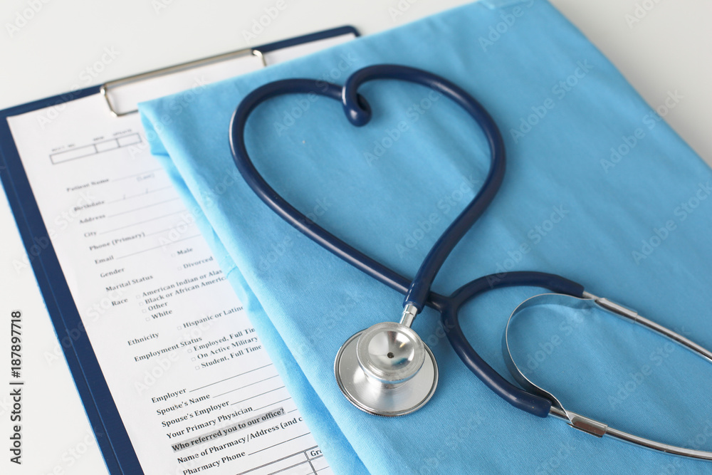 Stethoscope on a table with medical uniform Stethoscope on a table with medical uniform