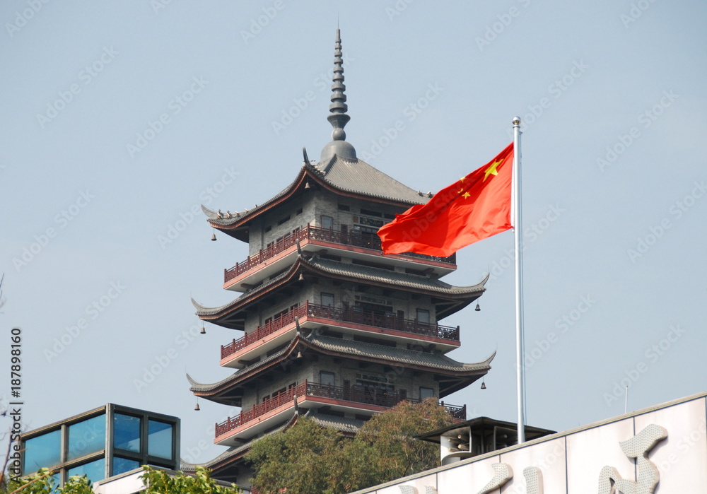 A seven storied pagoda in Foshan with waving Chinese flag A seven storied pagoda in Foshan with waving Chinese flag