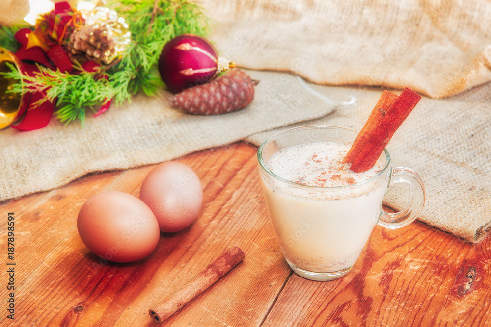 Fototapeta premium Homemade White Holiday Eggnog with a Cinnamon Stick