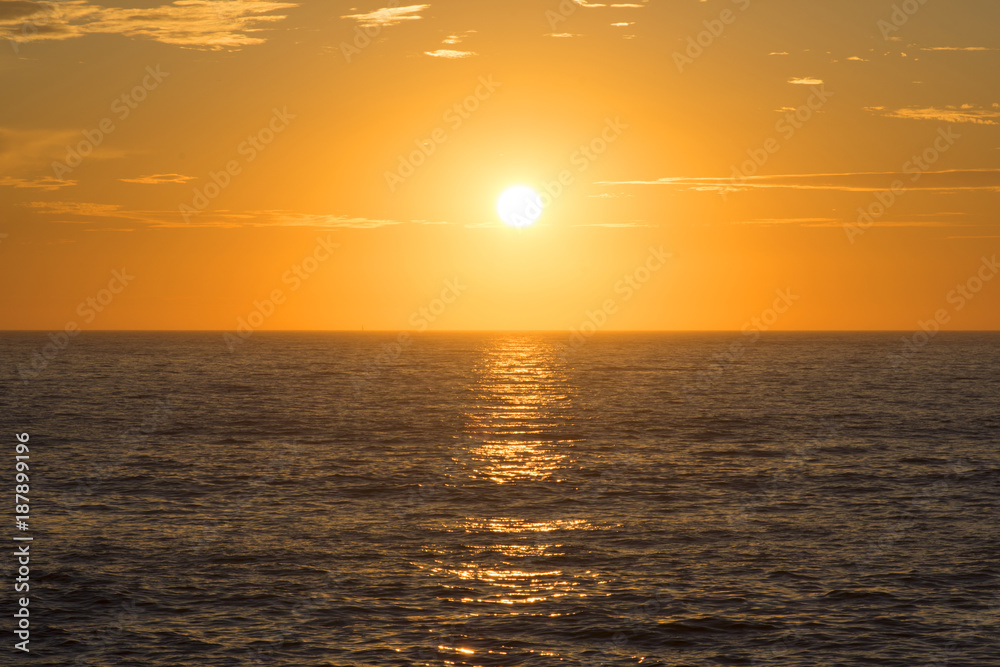 Golden sunset centered over empty ocean