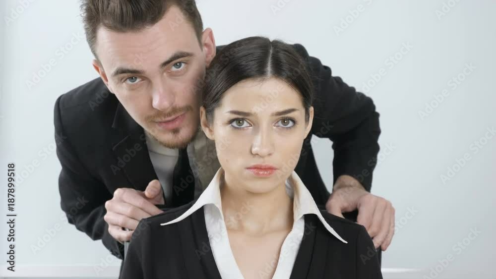Harassment. Young boss in a suit whispers in the ear of his secretary. The girl is angry and in perplexity 60 fps Harassment. Young boss in a suit whispers in the ear of his secretary. The girl is angry and in perplexity 60 fps