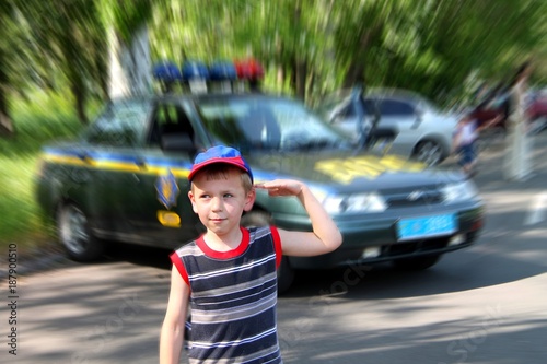 Little boy, disguised as a policeman, from behind photo