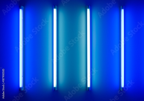 four neon tubes or lamps on the wall