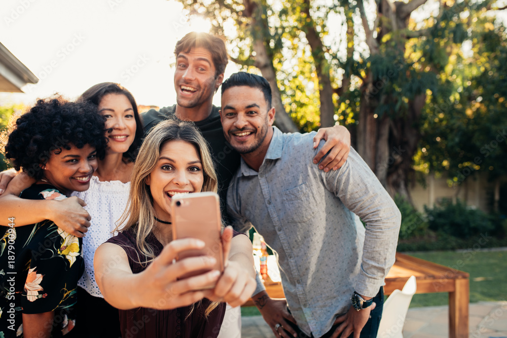 Fototapeta premium Group of friends at housewarming party taking selfie