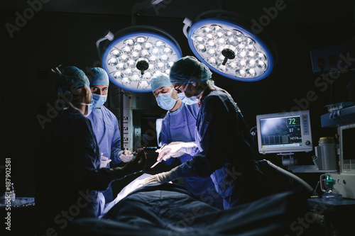 Fototapeta Medical team performing surgery in hospital