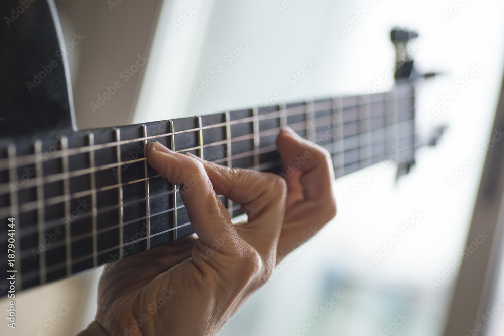 Elderly man playing carbon fiber guitar Elderly man playing carbon fiber guitar