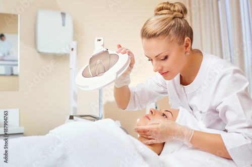 Cosmetologist is a professional with a patient in the office of a medical clinic. photo