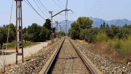 Railroad tracks leading through mountains.