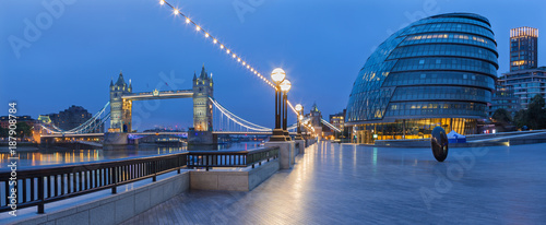 LONDON, GREAT BRITAIN - SEPTEMBER 19, 2017 - The panorama of the Tower bridge, promenade with the the modern Town Hall building at dusk. photo