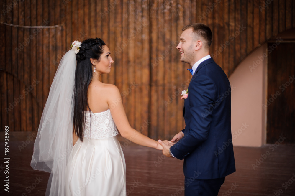 Beautiful and young married couple holding one anothers hands Beautiful and young married couple holding one anothers hands