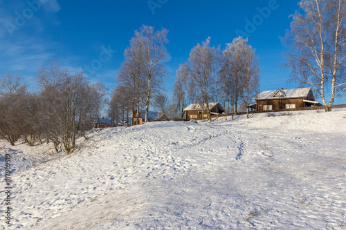 wooden houses on a mountain in winter © Vitaly