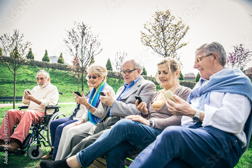 Senior people watching smartphones © oneinchpunch