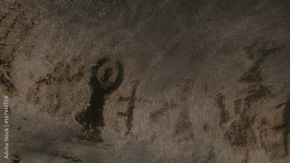 Slow pan on older than 7000 years decorations inside cave footage - Prehistoric wall paintings of Magura