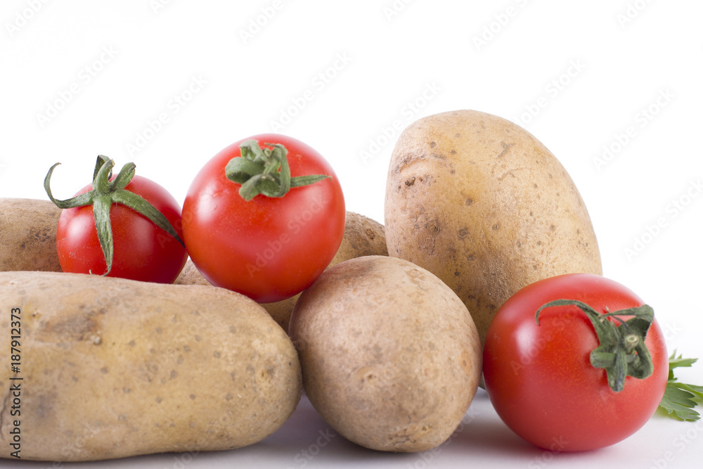 Potatoes and tomatoes on a white background. Potatoes on a white background. Red tomatoes with potatoes Potatoes and tomatoes on a white background. Potatoes on a white background. Red tomatoes with potatoes
