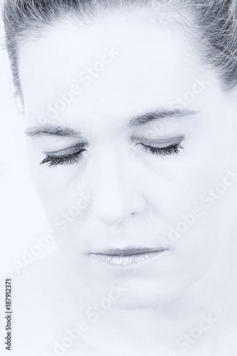 High key portrait of a woman with empty expression on her face