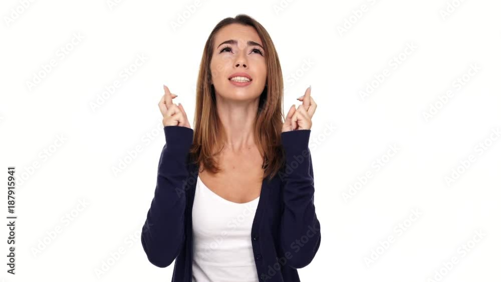 Concentrated brunette woman praying with crossed fingers and hands in pray gesture and rejoice after that over white background
Concentrated brunette woman praying with crossed fingers and hands in pray gesture and rejoice after that over white background