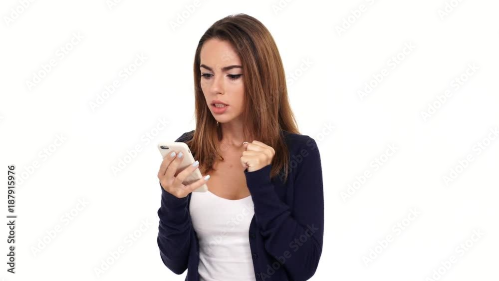 Worried brunette woman using her smartphone and rejoice after that over white background Worried brunette woman using her smartphone and rejoice after that over white background