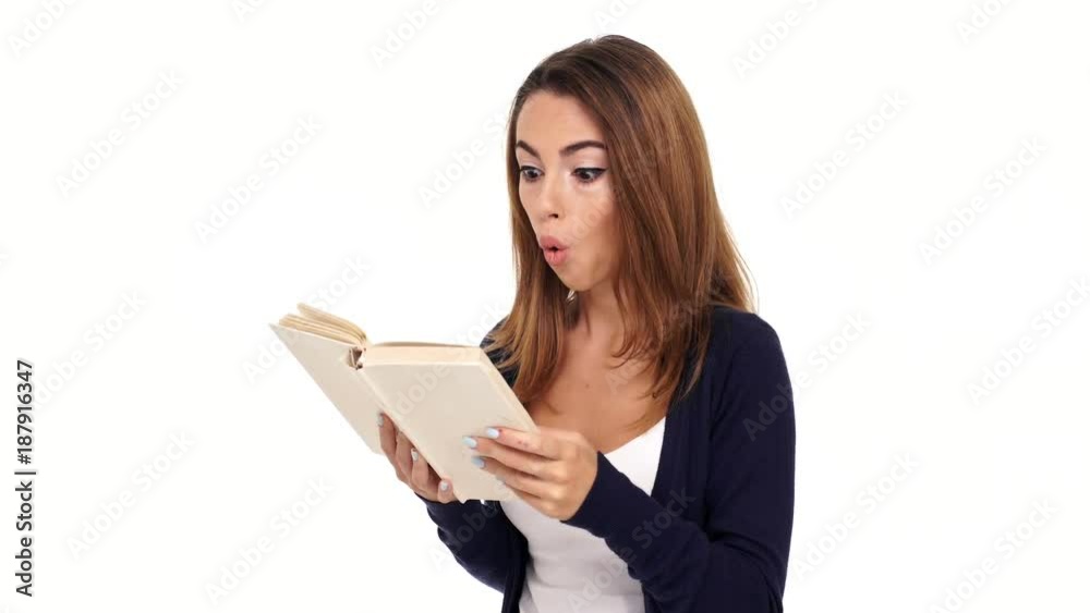 Surprised brunette woman reading book over white background Surprised brunette woman reading book over white background