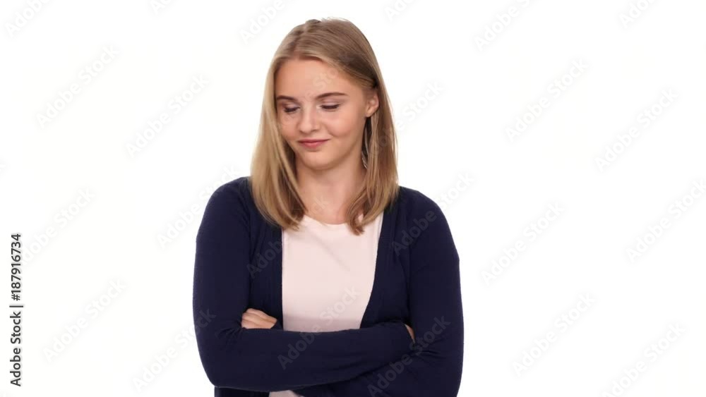 Smiling blonde woman in cardigan holding crossed arms while disagree with something over white background
Smiling blonde woman in cardigan holding crossed arms while disagree with something over white background