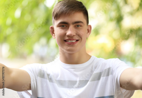 Trendy teenage boy taking s...