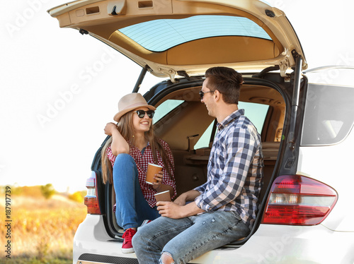 Beautiful young couple sitt...