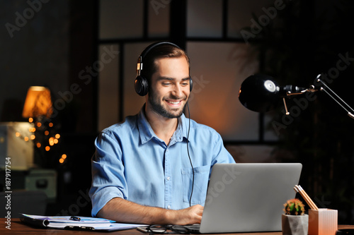 Young man using laptop and ...