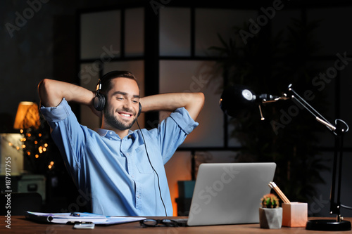 Young man using laptop and ...
