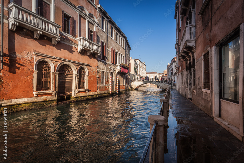 VENICE, ITALY - JANUARY 02 2018: Venetian canal with bridge and colorful houses