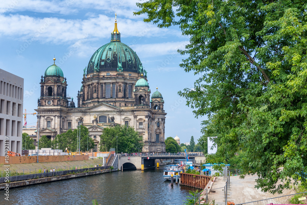 BERLIN, GERMANY - JULY 24, 2016: City Cathedral along Spree river in summer. Berlin attracts 20 million people annually