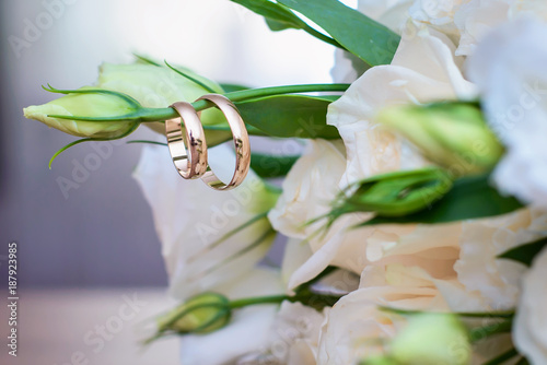 Wedding rings hanging on a twig bridal bouquet