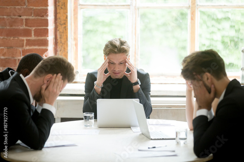 Photos Stressed boss and executive team searching problem solution at meeting, partners