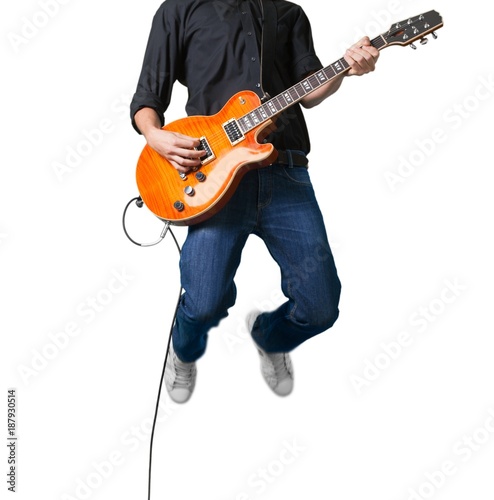 Portrait of a Musician Jumping while Playing an Electric Guitar