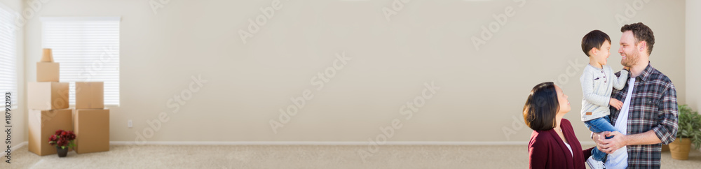 Young Mixed Race Caucasian and Chinese Family Inside Empty Room with Moving Boxes Banner.
