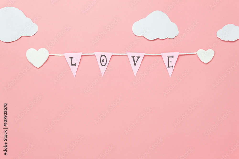 Table top view image of decoration valentine's day background concept.Text sign of season with paper cut clothesline love on beautiful pink sky with cloud.Several objects on pink wallpaper.pastel tone