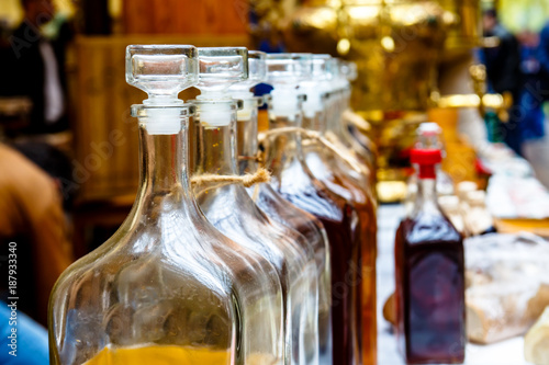 Transparent bottles of different alcoholic beverages - cordials and liqueurs.