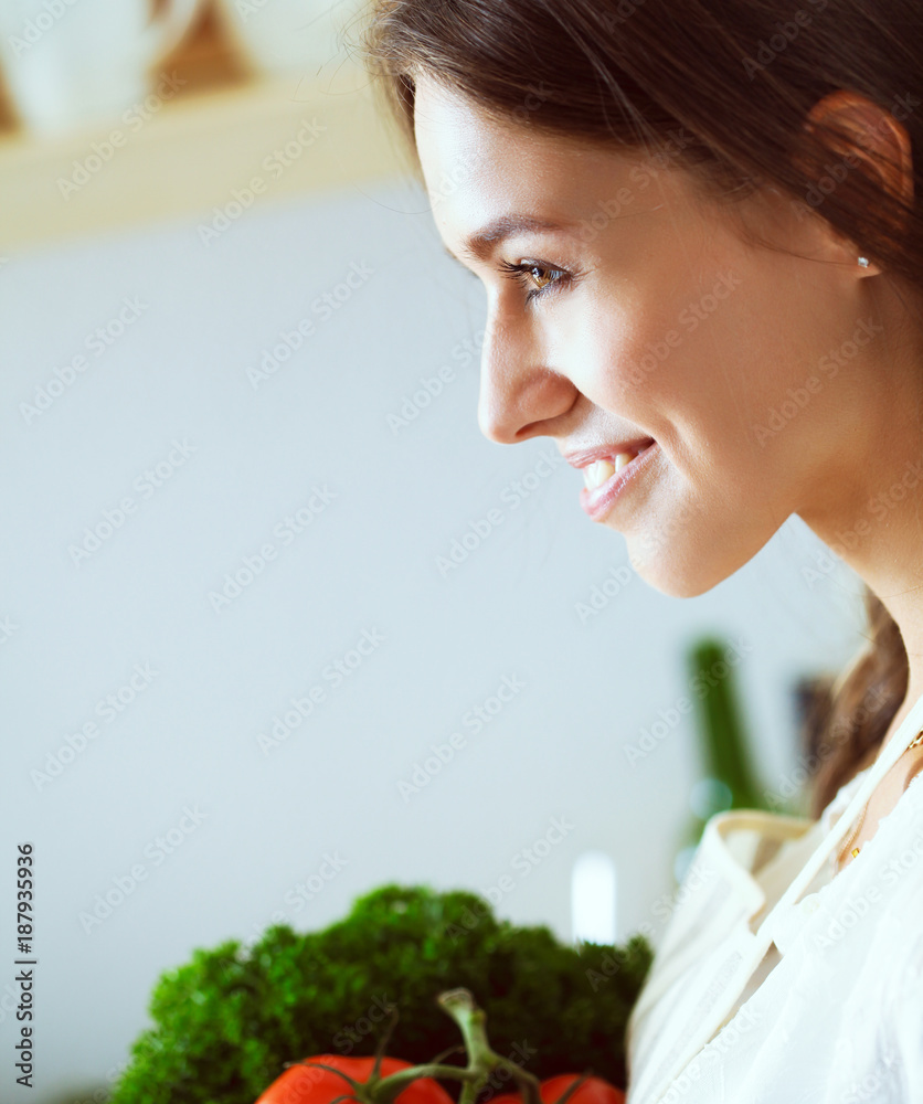 Young woman standing near desk in the kitchen Young woman standing near desk in the kitchen
