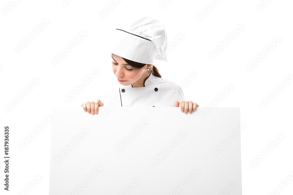 Pretty chef looking at the menu Pretty chef looking at the menu