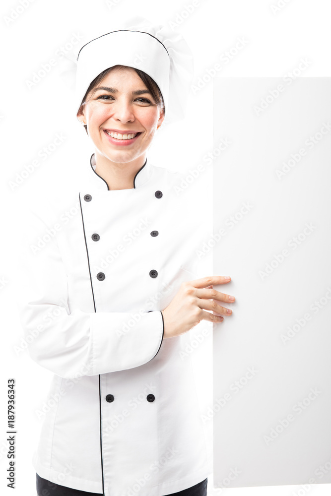 Cute Hispanic chef holding a sign Cute Hispanic chef holding a sign