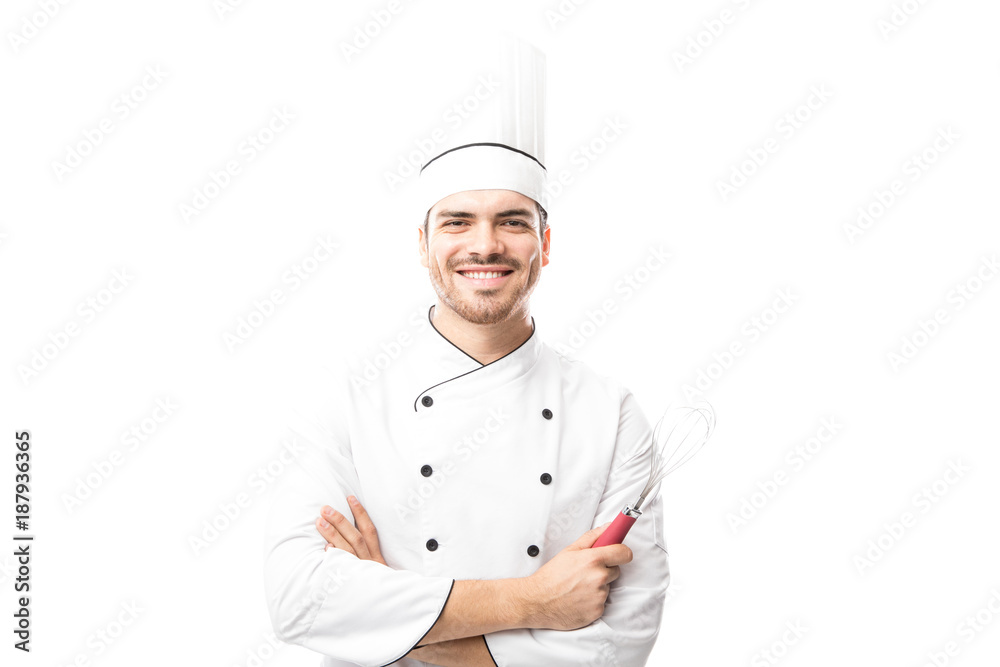 Chef holding a whisker and smiling Chef holding a whisker and smiling