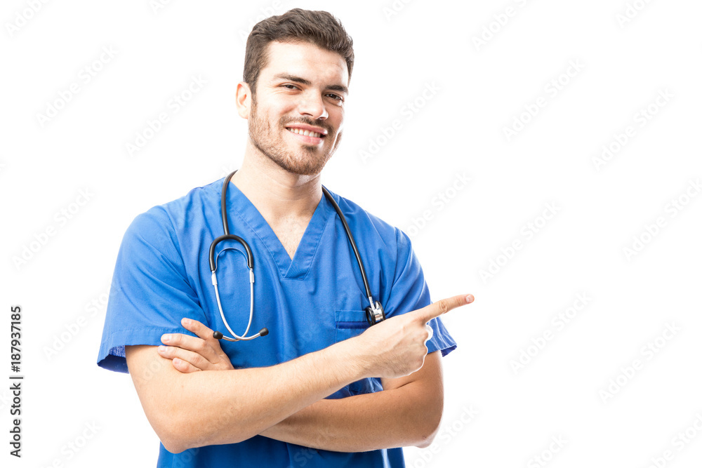 Male doctor pointing to copy space Male doctor pointing to copy space