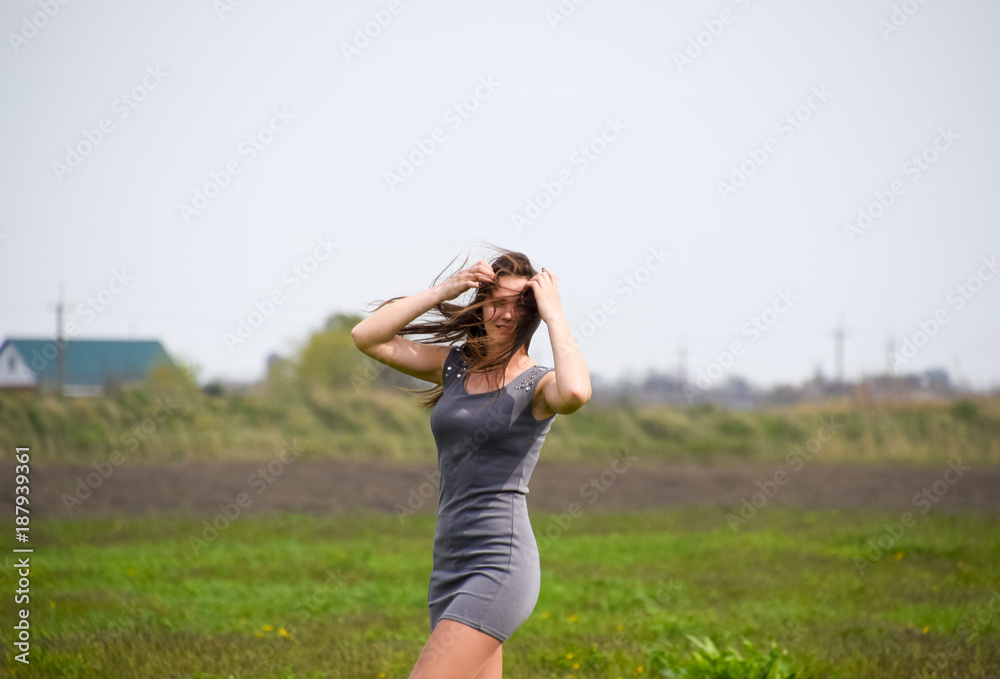 Beautiful fairy young girl in a field among the flowers of tulips. Portrait of a girl on a background of red flowers and a green field. Field of tulips. Beautiful fairy young girl in a field among the flowers of tulips. Portrait of a girl on a background of red flowers and a green field. Field of tulips.