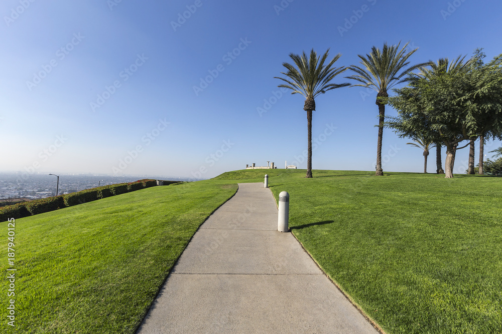 Palm trees, green grass and city views at Signal Hill Hilltop Park in Long Beach California.  