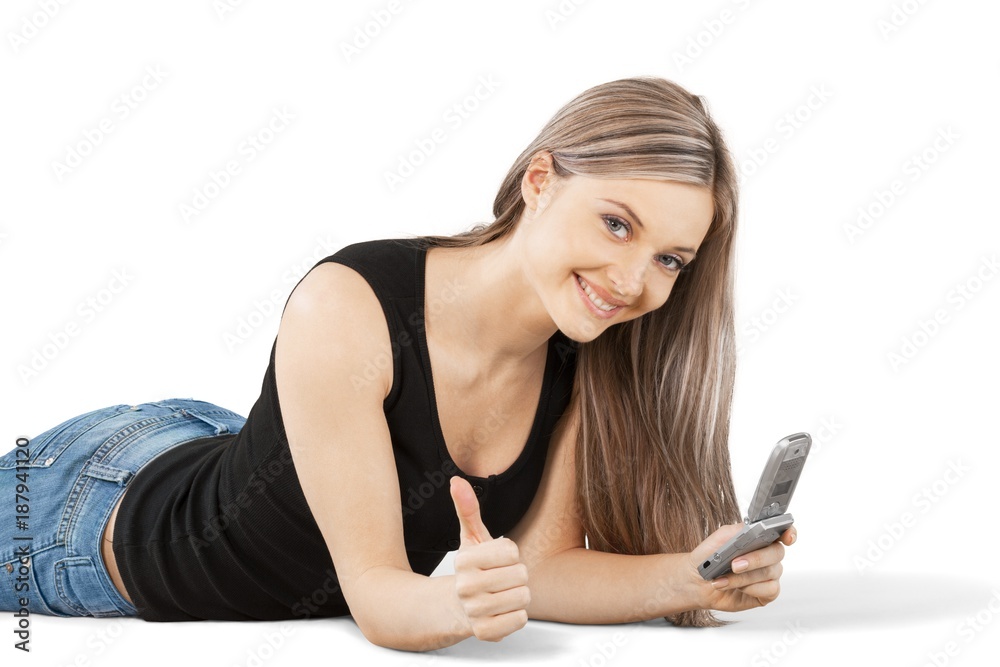 Smiling Woman Lying Down with Phone and Thumb Up - Isolated Smiling Woman Lying Down with Phone and Thumb Up - Isolated