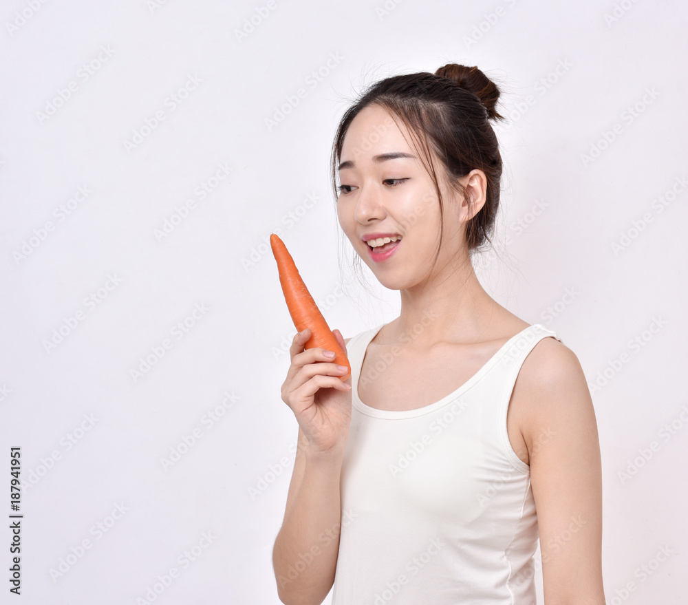 Young woman with white teeth eating healthy carrot food. Young woman with white teeth eating healthy carrot food.