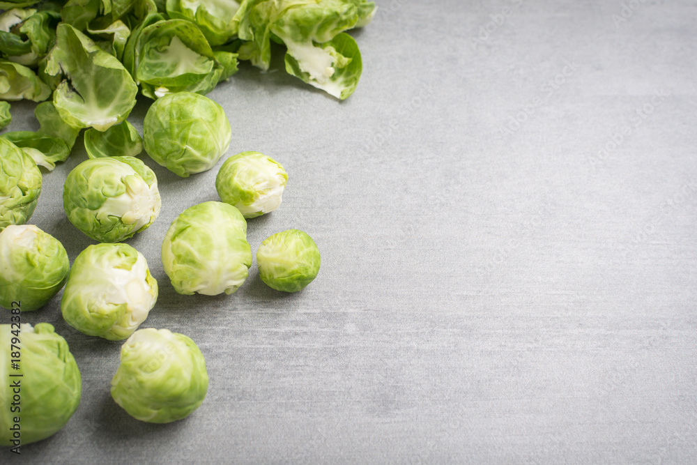 Brussel sprouts and peels on a stone background. Brussel sprouts and peels on a stone background.