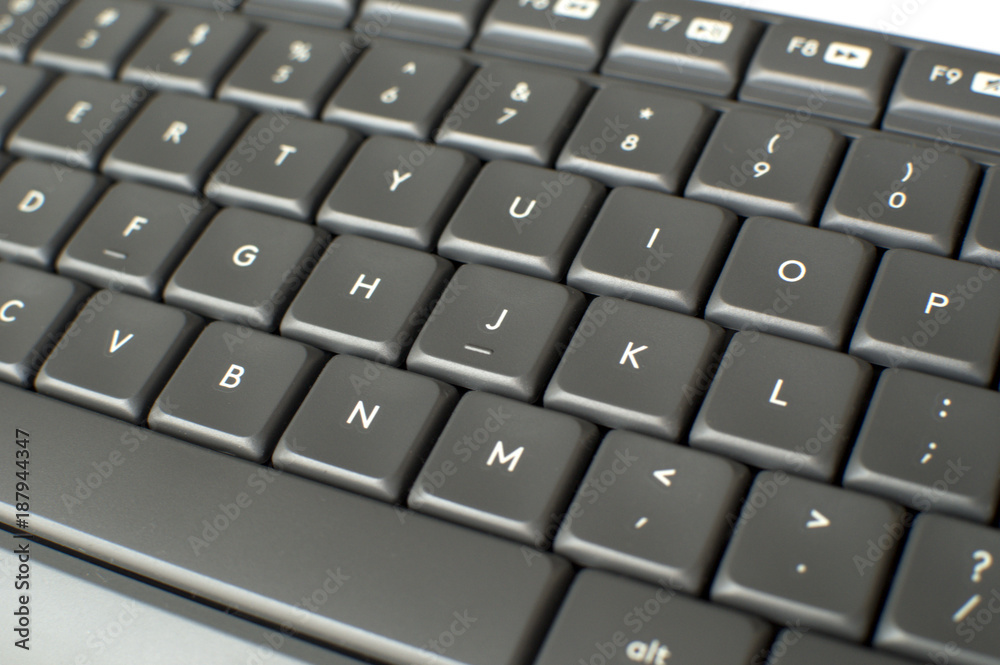 A close up picture of a gray keyboard