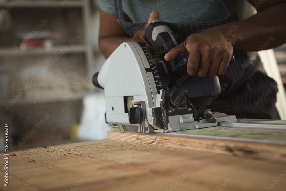 Mid section of carpenter leveling wood Mid section of carpenter leveling wood