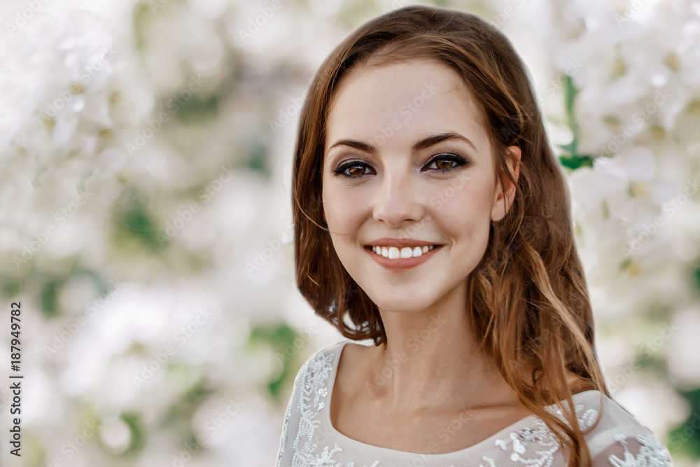 Beautiful smiling woman in a spring garden