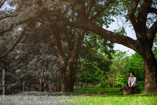 Global Warming and Pollution Concept man relaxing in nature park.